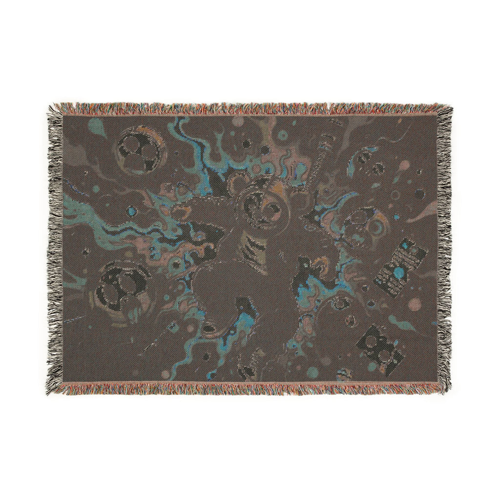 Reverse side of a fringed woven blanket.