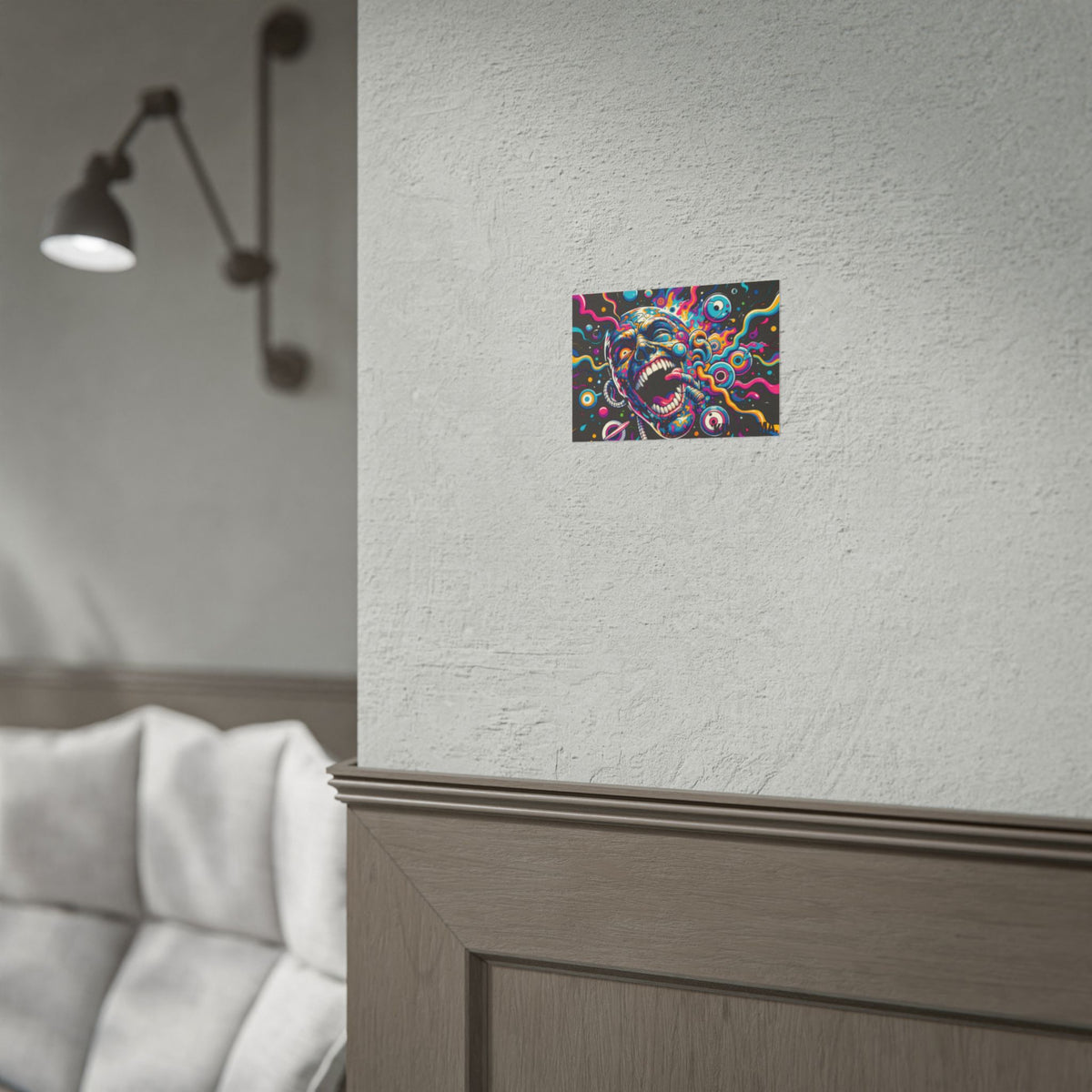Colorful screaming-face poster displayed above a sofa.