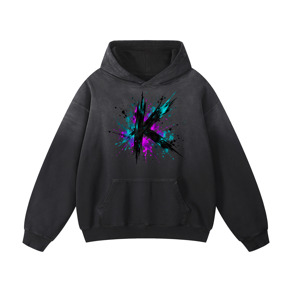 Front view of a black oversized hoodie with a K and colorful paint splashes.
