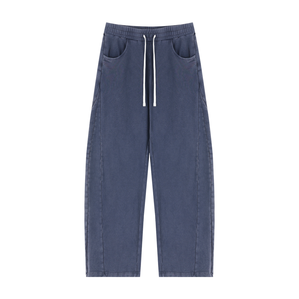A pair of wide-leg, relaxed-fit pants in washed blue denim, featuring a white drawstring at the elastic waistband and side pockets, shown against a plain white background.