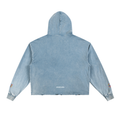 A light blue acid-wash cropped hoodie shown from the back, featuring a hood, long sleeves, and small colorful embroidered details on the cuffs, with 'KURFLAMA' printed in white near the bottom hem.